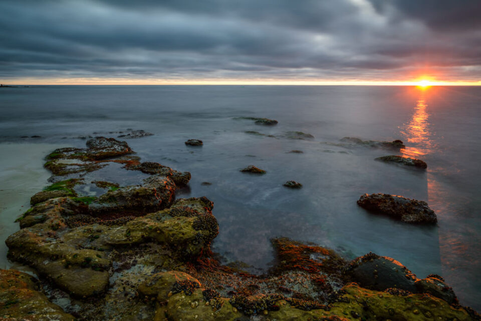 这张风景照片是用尼康18-35mm f/3.5-4.5 G镜头拍摄的，展示了太阳在海洋上落下。